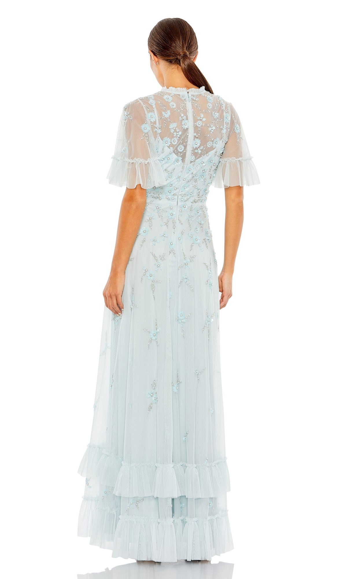 A woman with long brown hair in a ponytail is seen from the back, wearing the Mac Duggal 9199—a stylish short sleeve beaded formal gown.